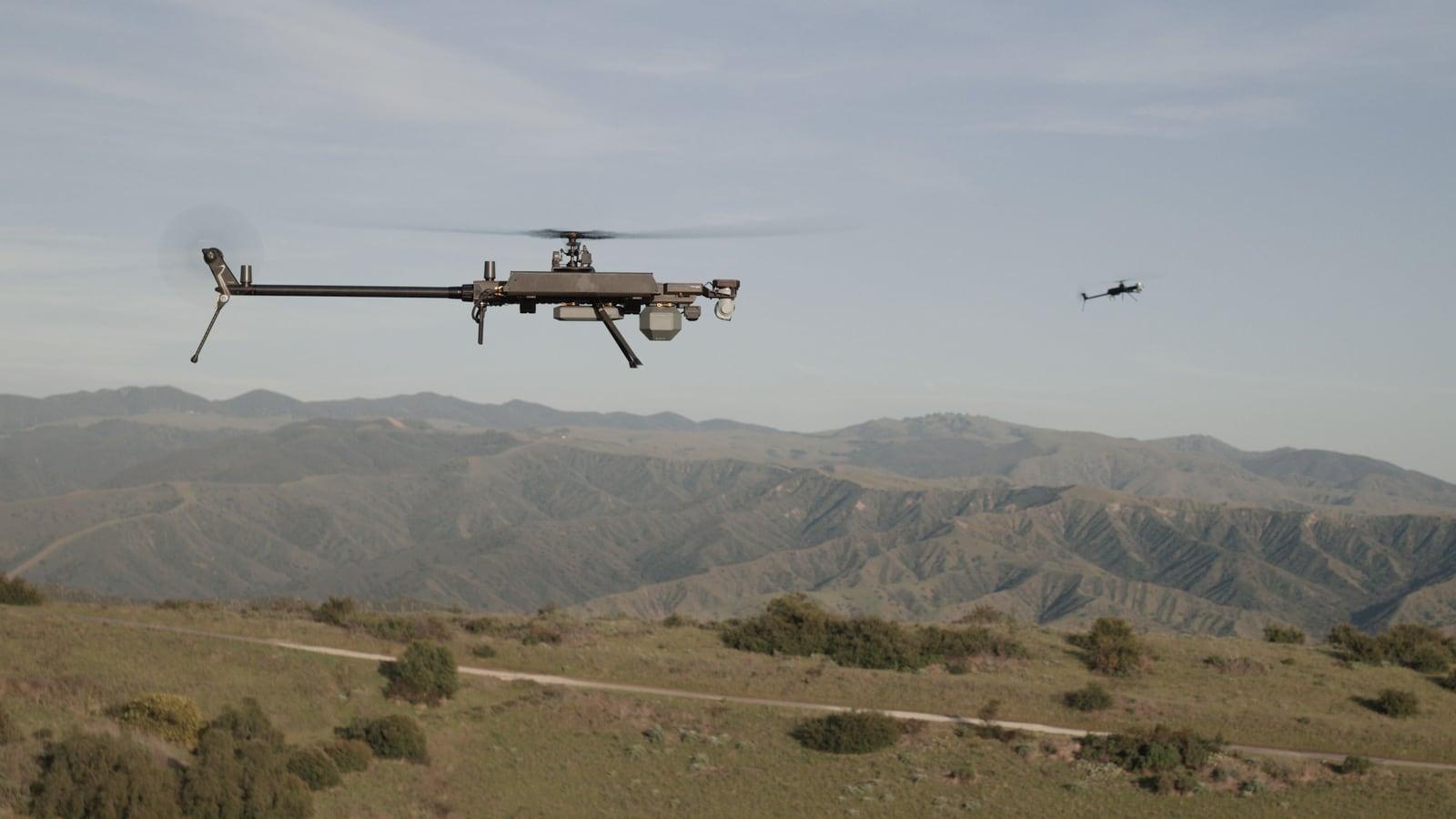 Ghost-X in flight over mountainous terrain at sunset